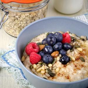 Oatmeal topped with a vibrant mix of berries, nuts, and seeds