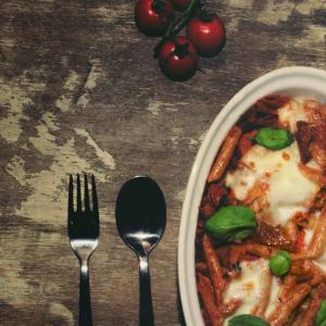 Mouth watering vegetarian pasta bake with rich tomato sauce and cheese toppings
